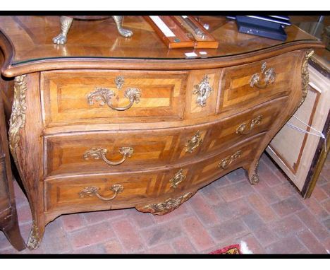 A continental antique bombe shaped commode with gilt mounts - 128cm wide 