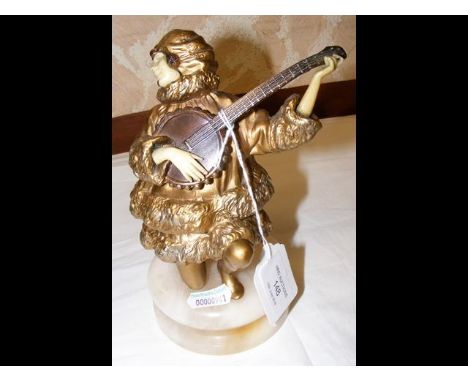 An Art Deco style 18cm high figure of lady playing banjo 