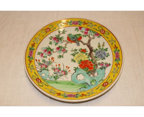 A 19th Century Chinese circular charger with bird and floral decoration within yellow borders, 12½" diameter