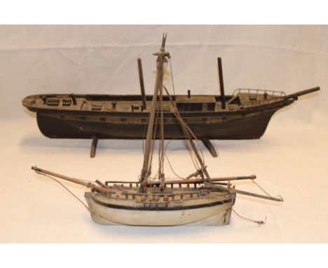 An old wooden scale-built model of a single masted sloop, 16" long and one other wooden scale-built boat model (2) 