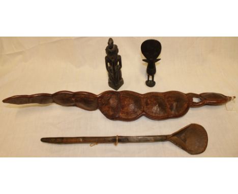 An African carved wood figure of a pipe player, 9" high; African carved wood fertility-style figure, unusual dried seed pod a