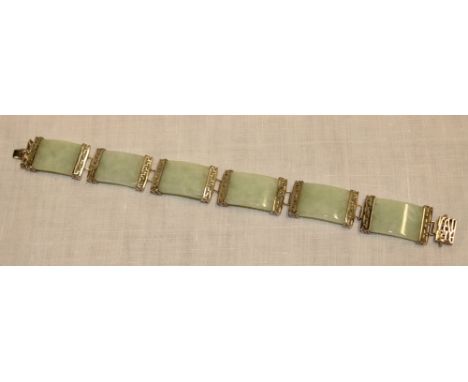 A silver rectangular link bracelet mounted with six jade panels 