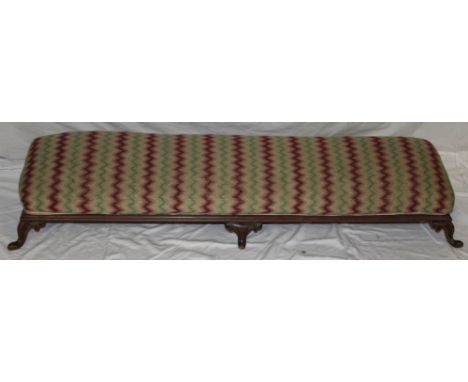 An Edwardian mahogany rectangular fender stool with upholstered seat on six scroll legs, 46" long 