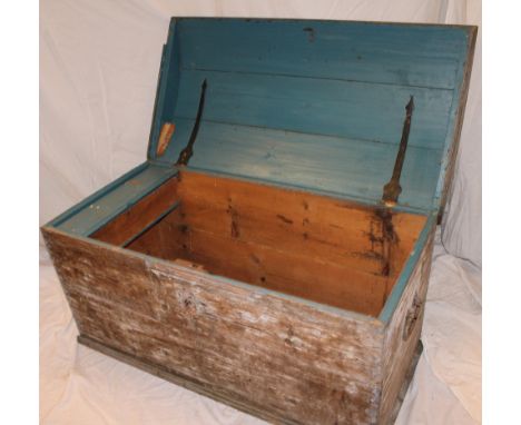 A polished pine domed trunk with hinged lid and iron handles, 42½" long