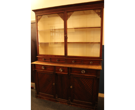 An unusual Folk Art pitch pine kitchen dresser, possibly Cornish, the base with three drawers in the frieze and cupboard encl