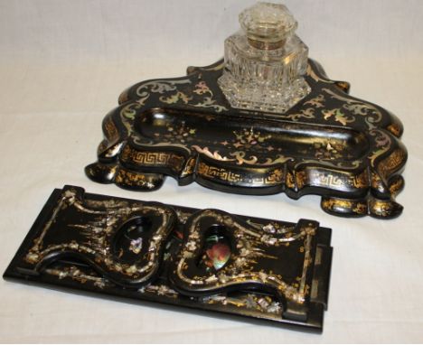 A Victorian lacquered paper-mache desk stand supporting a cut-glass hexagonal inkwell, the stand inlaid with mother of pearl 