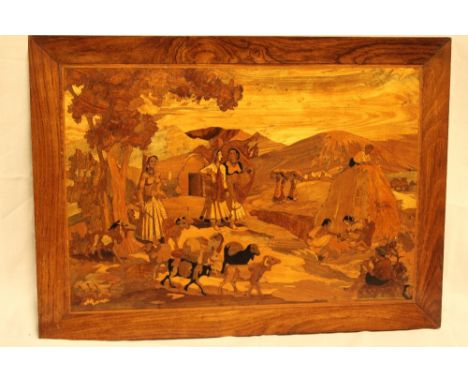 An Indian marquetry rectangular panel depicting various female labourers and goats, 25½" x 19" 