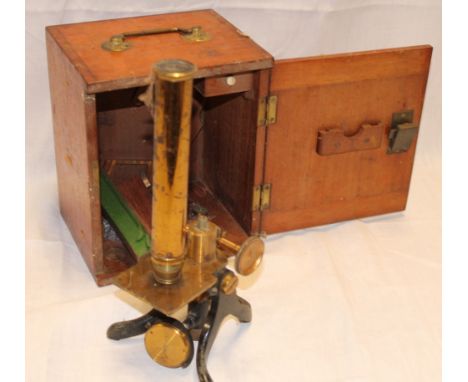 A brass and painted metal monocular microscope in fitted mahogany case 