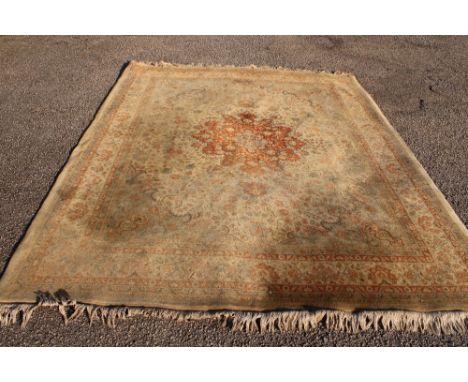 A good quality modern tabriz-style wool carpet with floral decoration on cream ground 10' x 8'