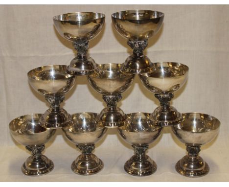 Nine silver-plated wine goblets with grape decorated stems on circular bases