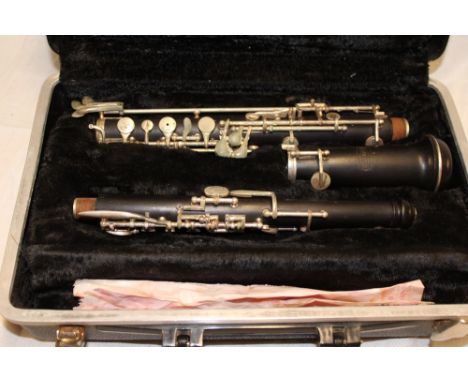 An ebony oboe with nickel plated mounts by Bundy in fitted case 