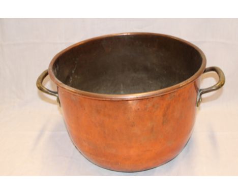 A 19th Century copper circular cooking pan with brass handles, 15" diameter