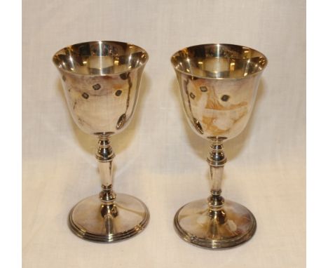A pair of good quality silver wine goblets with tapered stems and circular bases, 6" high, Sheffield marks 1974