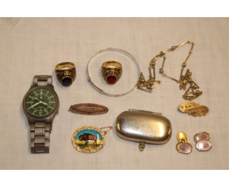 A silver and enamel buffalo brooch, pair of silver cuff-links, nickel-plated sovereign case, two United States services signe
