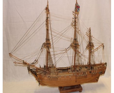 A wooden scale built model three masted Napoleonic-style frigate with deck detail, 29" long overall in glazed display case