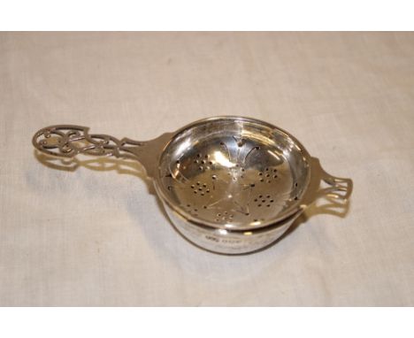 A George VI silver tea strainer with pierced handle and matching bowl, Sheffield marks 1943 