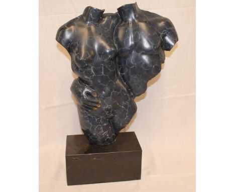 A modern coloured bronze abstract figure of a male and female form on black marble base, 20" high