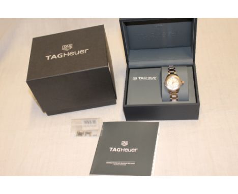 A lady's Tag Heuer Aquaracer wrist watch in 18ct gold mounted stainless steel mounts, the dial with 12 diamonds, boxed with c
