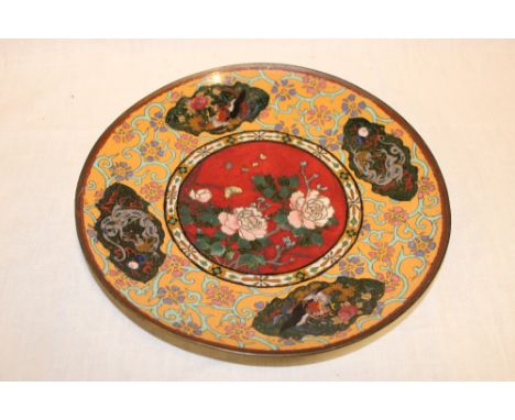 A Japanese Cloisonne enamelled circular charger with floral decoration on red and brown ground, 12" diameter