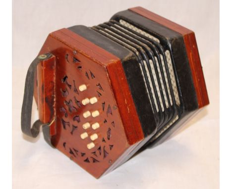 An old hexagonal concertina by Lachenal of London with bone buttons and fret-work panels