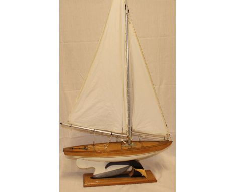 A good quality wooden model pond yacht with linen sails and weighted base 25" long