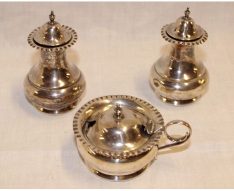 A pair of Edward VII silver baluster-shaped pepperettes together with matching lidded mustard pot, Sheffield marks 1906 