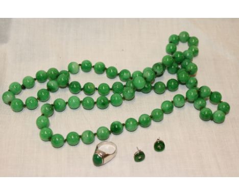 A natural jade necklace, silver dress ring mounted jade and a pair of silver mounted jade earrings