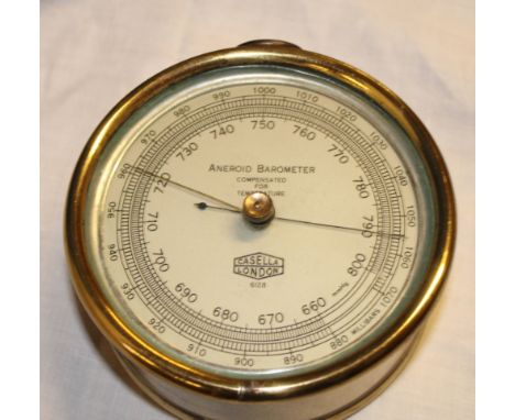 An aneroid barometer by Casella of London in brass cylindrical case