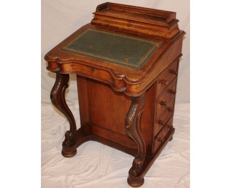 A Victorian figured walnut Davenport desk with satin lined interior and hinged stationery compartment above four short side d