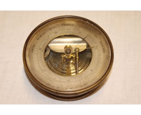 An aneroid barometer by Smith Beck and Beck of London with silvered circular dial in brass case 