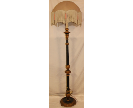 A good quality ornate painted standard lamp with tapered stem and circular base supporting a period shade