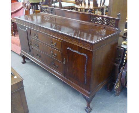 A FIGURED MAHOGANY SIDEBOARD, IN CHIPPENDALE STYLE WITH TRELLIS PIERCED LEDGE BACK, GADROON BORDERS OVER A BLIND FRET CARVED 