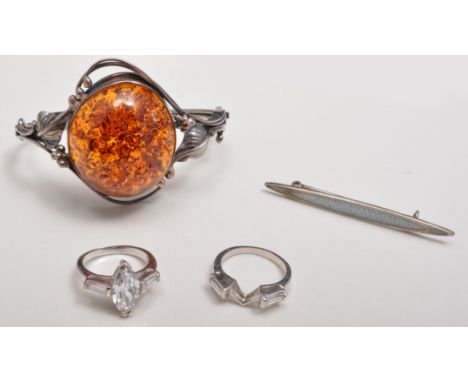 White metal hinged bangle, set with amber cabochon, silver and enamel bar brooch and two dress rings.