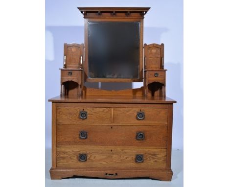 Edwardian oak three piece bedroom suite, comprising a double wardrobe with a projecting cornice, Art Nouveau style inlaid pan