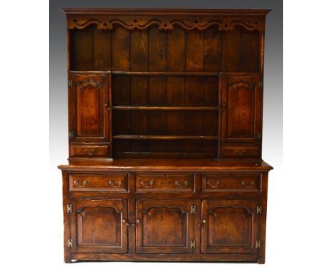 Reproduction oak dresser, shelf rack, cupboards and drawers, the base with three drawers over three fielded panel doors, leng