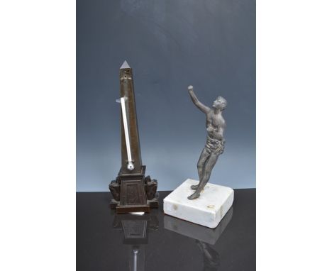 Bronzed obelisk desk thermometer, 28cm and a Britannia metal figure of a slave, set on a marble plinth (2).