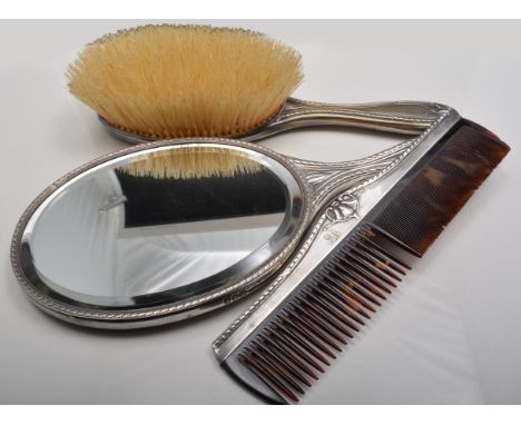 Edwardian silver dressing table set, makers mark CD, comprising a rectangular tray, 28cm x 20cm, hand mirror, a pair of cloth