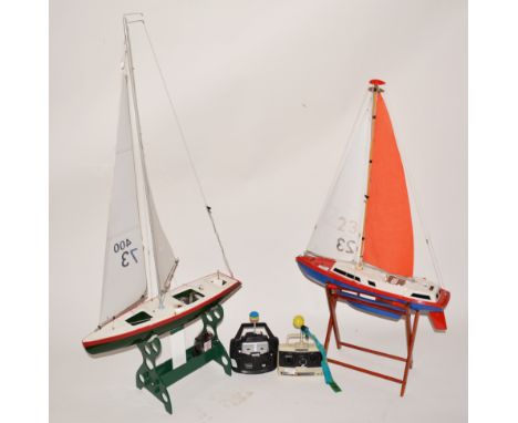 Two R/C model yachts, with stand and radio