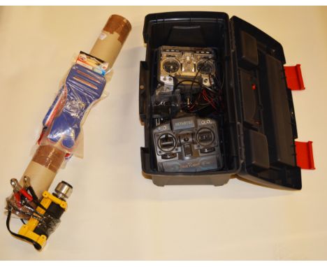 Tool box containing, 2 R/C transmitters and sundry Heli spares, plus tube containing rotor blades and starter.
