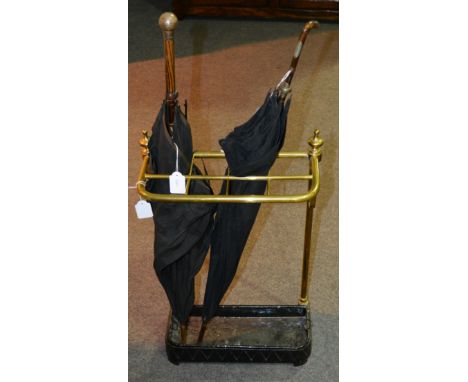 Brass stick stand, cast iron base, width 38cm.