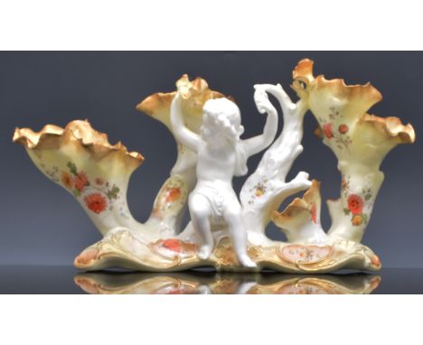 Moore Brothers centre piece, late 19th Century, modelled with a cherub and trunk like branches, decorated in colours, No. 928