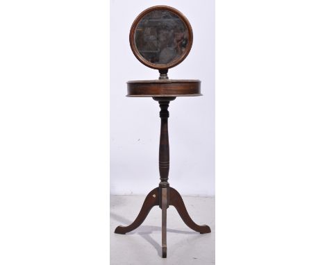 Stained walnut shaving stand, circular adjustable mirror, two hinge compartments to the drum, tripod legs, diameter 43cm.
