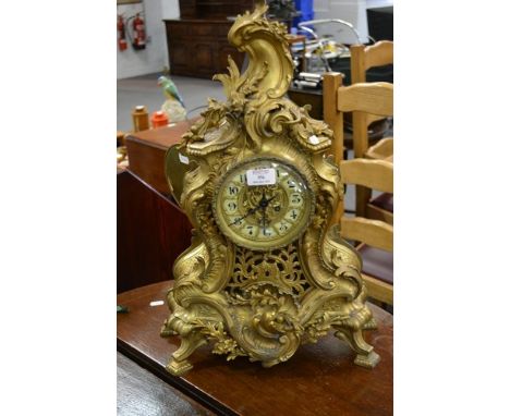 French gilt metal mantel clock, in the Louis XV style, ivorine numerals, cylinder movement, striking on a bell, 58cm.