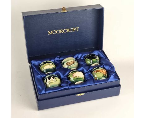 A set of six Moorcroft Farmyard Animal egg cups, dated 1999, decorated with sheep, ducks, cows, pigs and chickens, printed fa