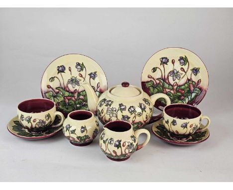 A Moorcroft 'Ashwood Hepatica' tea service in rare colourway, circa 2000, produced specially for the present vendor, comprisi