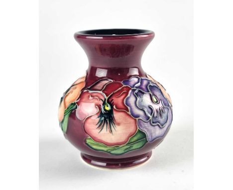 A small Moorcroft 'Pansy' vase, dated 1998, purple ground, 9.5cm high. Boxed.Provenance: The Peter Richards' Collection.

Ver