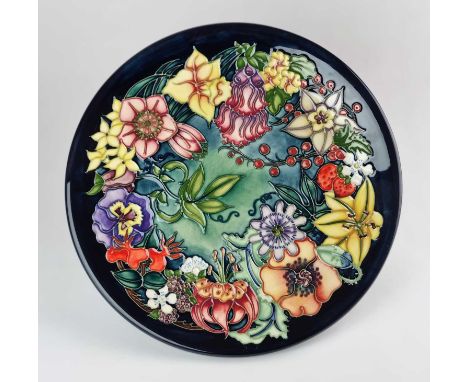 A large Moorcroft 'Carousel' charger designed by Rachel Bishop, dated 1997, a numbered edition '56', signed by both Rachel Bi