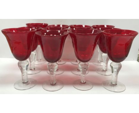 A set of twelve ruby and clear glass goblets, the bell shaped bowls on clear balluster stems to circular feet 11 cm diameter 