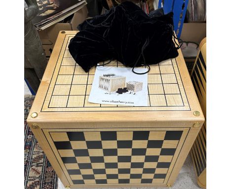 An Alison Henry game cube, each side printed with various games boards including backgammon, chess, noughts and crosses, etc,