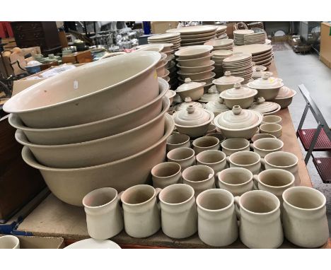 A large collection of oatmeal glazed pottery dinner wares bearing potter's mark impressed "R" within a square punch (unidenti